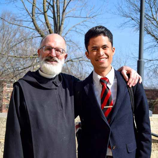 Fr. Gabriel Landis with a student